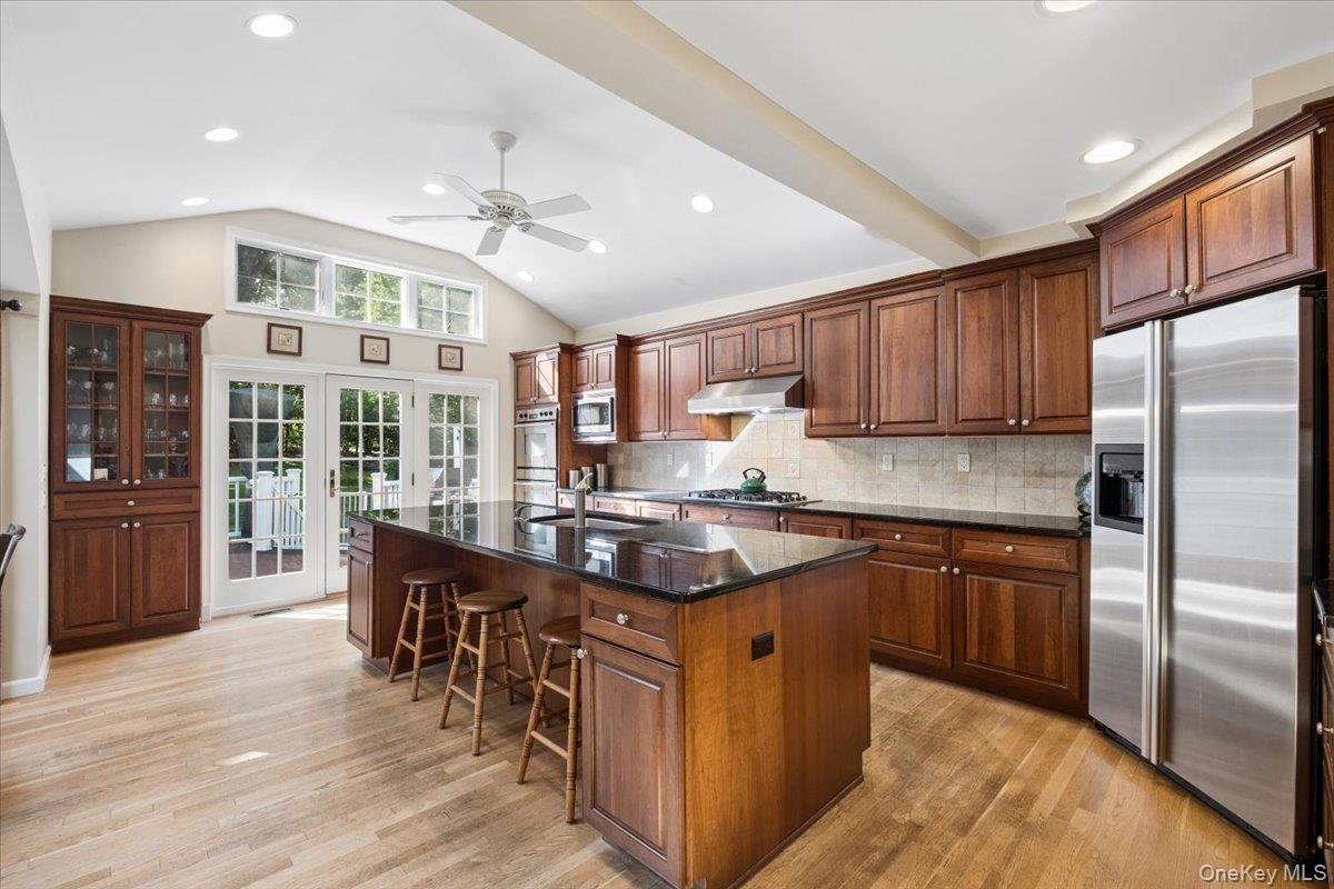 372 Fort Hill Road Scarsdale, NY 10583 - Photo 7 of 40 Sun-filled kitchen with custom cabinetry and stainless steel appliances with doors to expansive deck