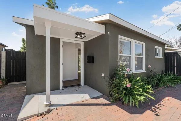 a view of a backyard with a tree