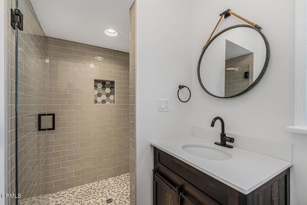 6131 Ranchito Avenue Los Angeles, CA 91401 - Photo 8 of 12 a bathroom with a sink a toilet and a mirror