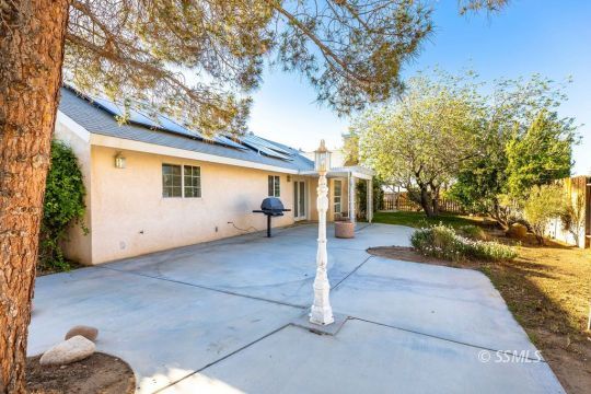 422 Vista Street Ridgecrest, CA 93555 - Photo 30 of 38 a view of a house with a yard and tree