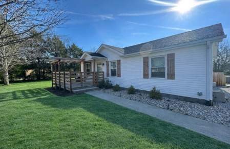 882 Pleasant Hill Road Franklin, KY 42134 - Photo 1 of 16 a front view of a house with garden