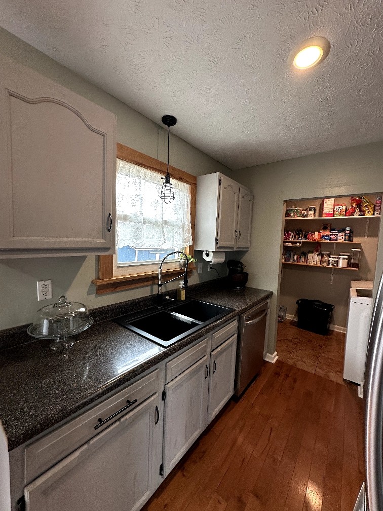 882 Pleasant Hill Road Franklin, KY 42134 - Photo 7 of 16 a kitchen with stainless steel appliances granite countertop a sink stove and cabinets