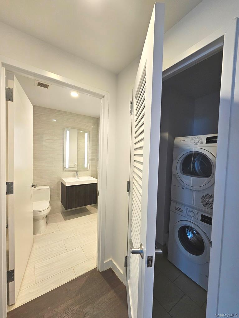 131-03 40 Road, Unit PH1Y Queens, NY 11354 - Photo 6 of 13 a view of a hallway and a bathroom with a sink