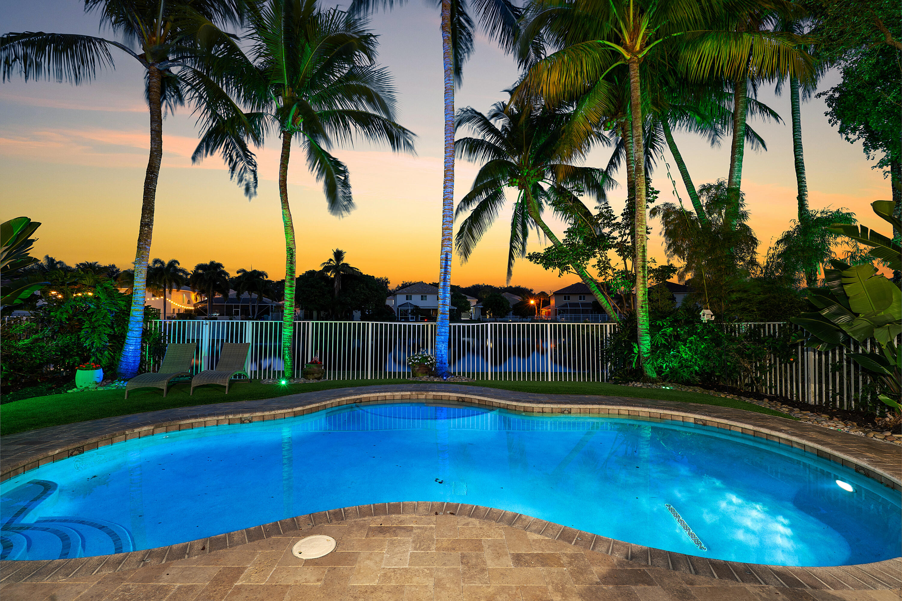 1135 Rialto Drive Boynton Beach, FL 33436 - Photo 32 of 54 a view of swimming pool with lawn chairs and palm trees