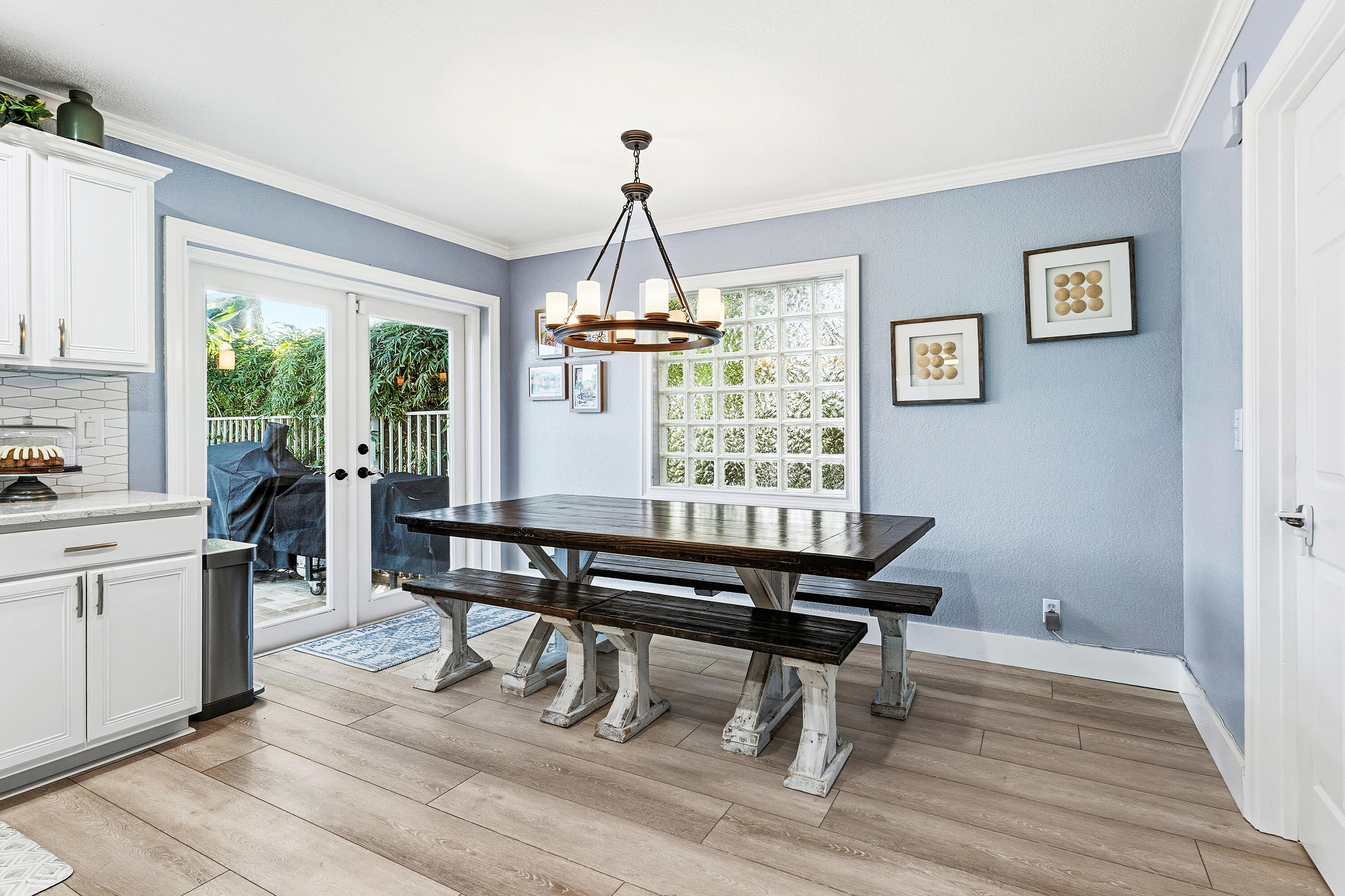 1135 Rialto Drive Boynton Beach, FL 33436 - Photo 9 of 54 a dining room with wooden floor a chandelier a wooden table and chairs