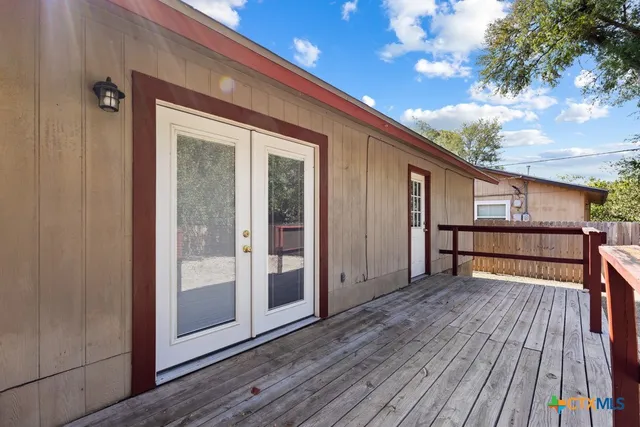 a view of backyard with a deck and wooden floor