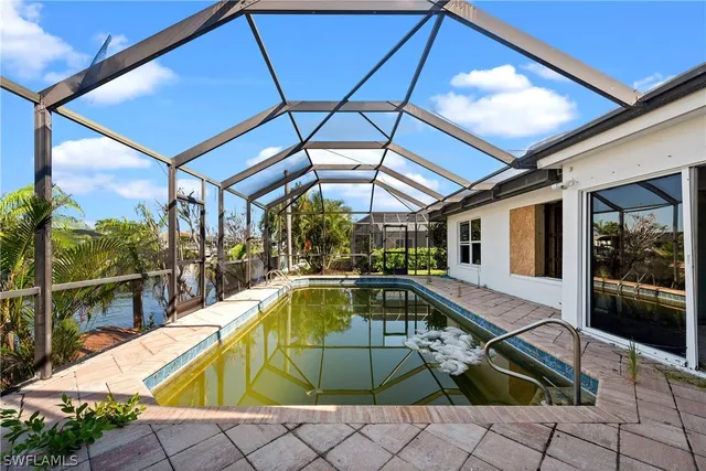 a view of a room with wooden floor and iron stairs