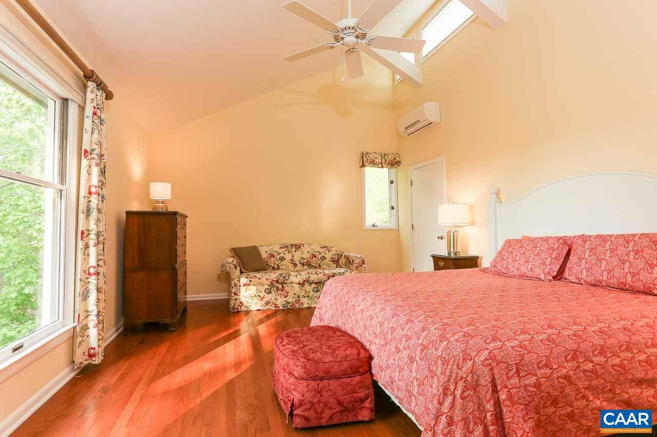 590 Explorers Road Charlottesville, VA 22911 - Photo 19 of 50 a bedroom with a bed and a chandelier