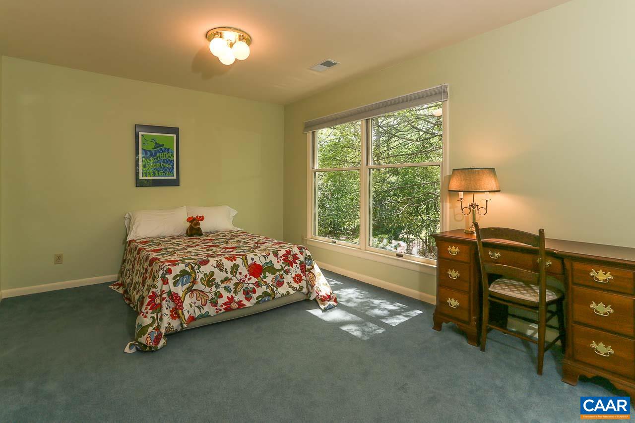 590 Explorers Road Charlottesville, VA 22911 - Photo 23 of 50 a bedroom with a bed and a lamp next to a window