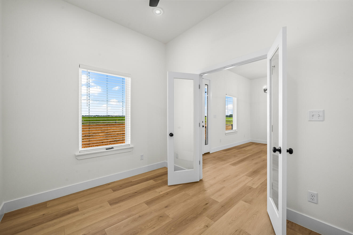 8115 County Road Shallowater, TX 79363 - Photo 16 of 47 a view of an empty room with wooden floor and a window