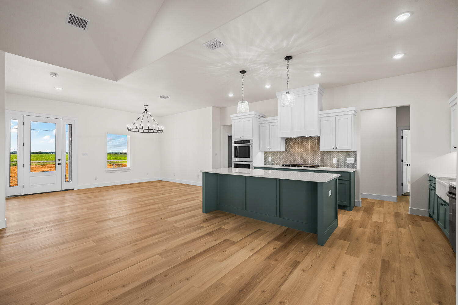 8115 County Road Shallowater, TX 79363 - Photo 20 of 47 a kitchen with granite countertop a stove and a wooden floors