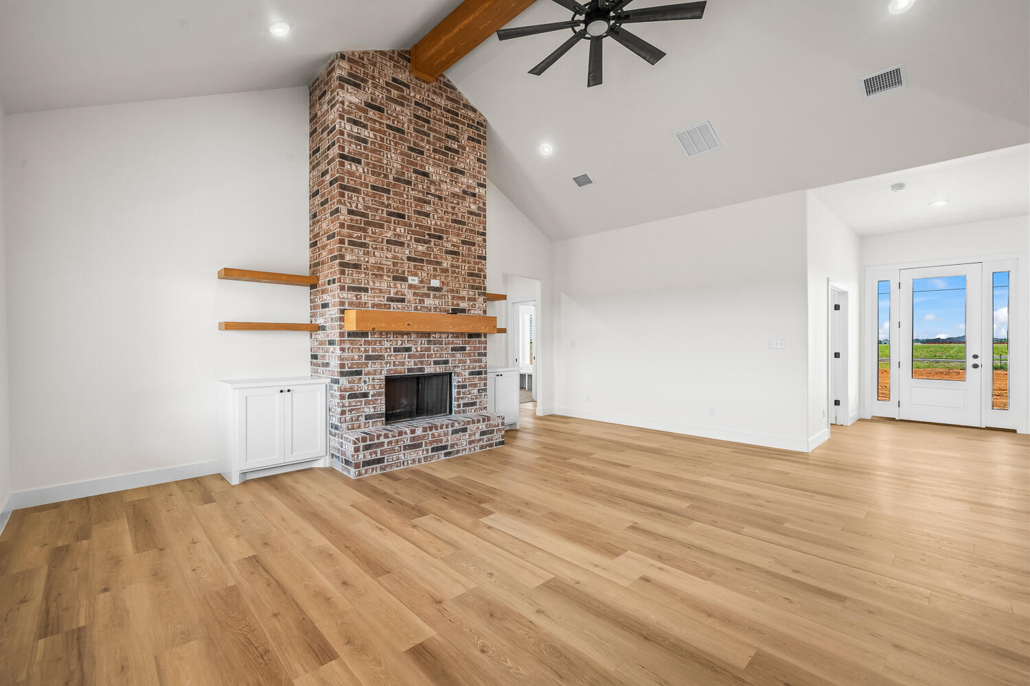 8115 County Road Shallowater, TX 79363 - Photo 29 of 47 a view of an empty room with a fireplace and a window