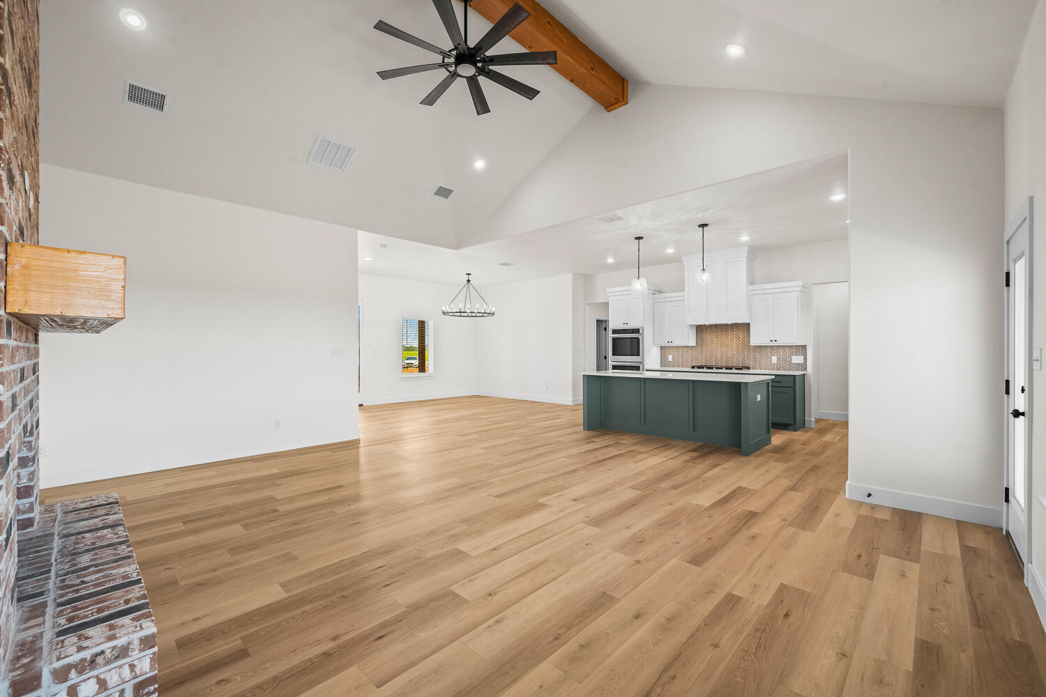 8115 County Road Shallowater, TX 79363 - Photo 30 of 47 a view of kitchen and empty room with wooden floor