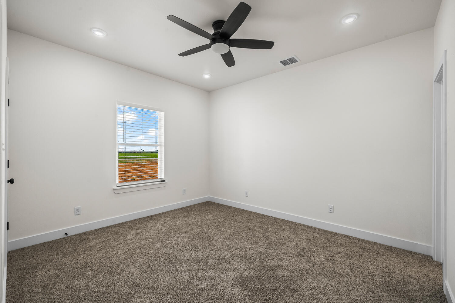8115 County Road Shallowater, TX 79363 - Photo 33 of 47 an empty room with a window and a fan