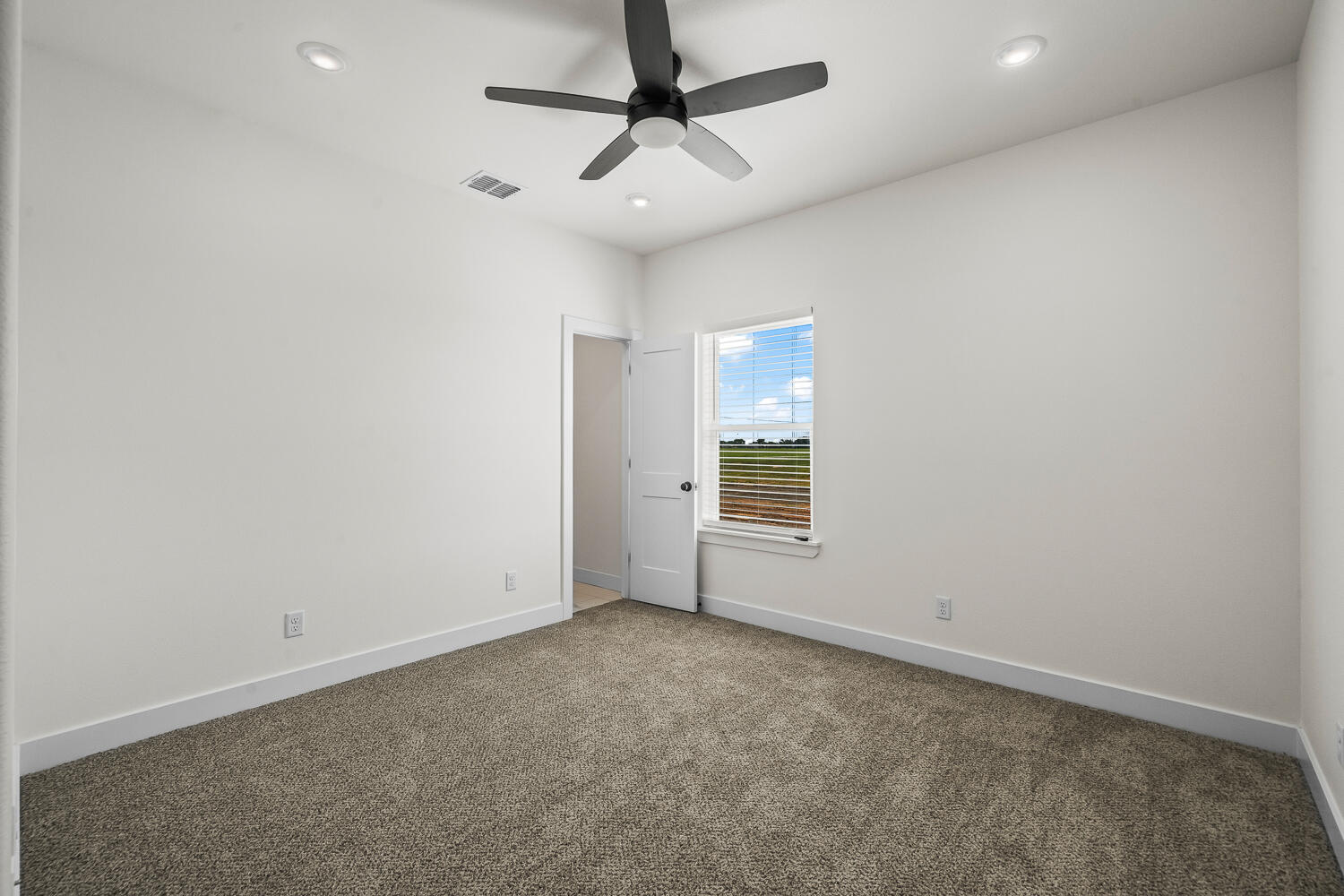 8115 County Road Shallowater, TX 79363 - Photo 39 of 47 en empty room with windows and ceiling fan