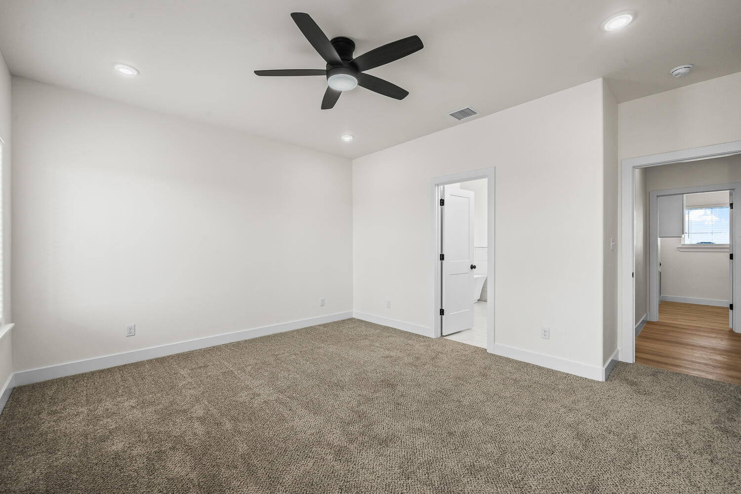 8115 County Road Shallowater, TX 79363 - Photo 6 of 47 an empty room with wooden floor and windows