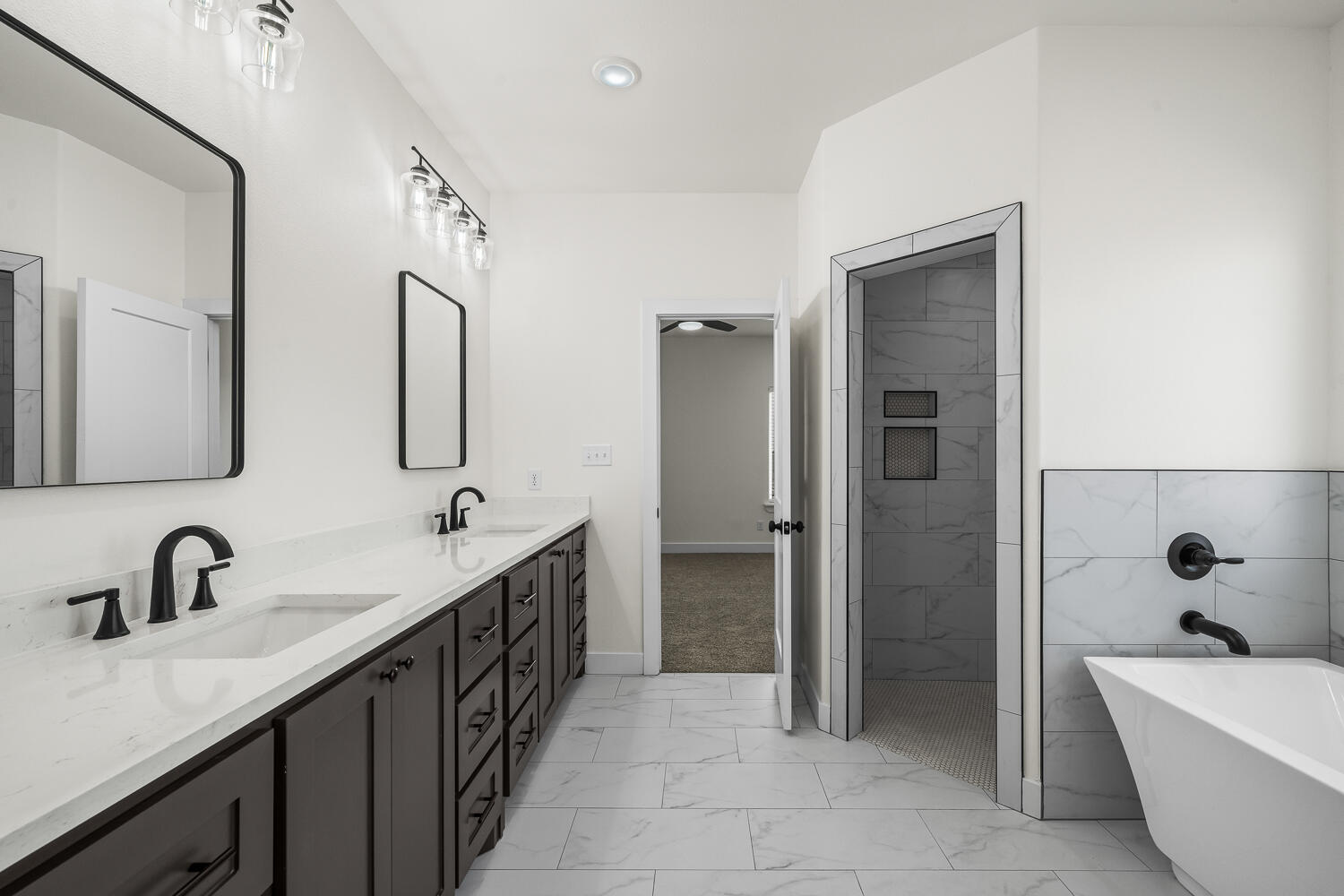 8115 County Road Shallowater, TX 79363 - Photo 10 of 47 a bathroom with a double vanity sink double mirror and bathtub