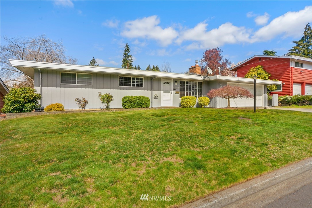 3322 Northeast 10th Place Renton, WA 98056 - Photo 2 of 21 a front view of a house with a yard