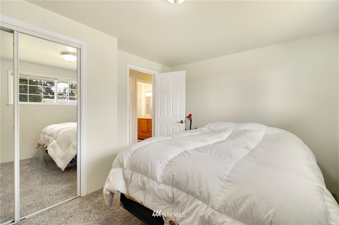 3322 Northeast 10th Place Renton, WA 98056 - Photo 16 of 21 a bedroom with a bed and white wall painting