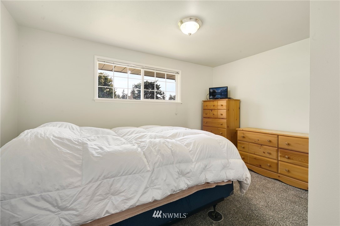 3322 Northeast 10th Place Renton, WA 98056 - Photo 17 of 21 a bedroom with a bed and dresser with mirror