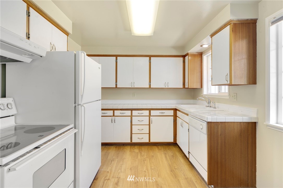 3322 Northeast 10th Place Renton, WA 98056 - Photo 9 of 21 a kitchen with a sink a refrigerator and cabinets