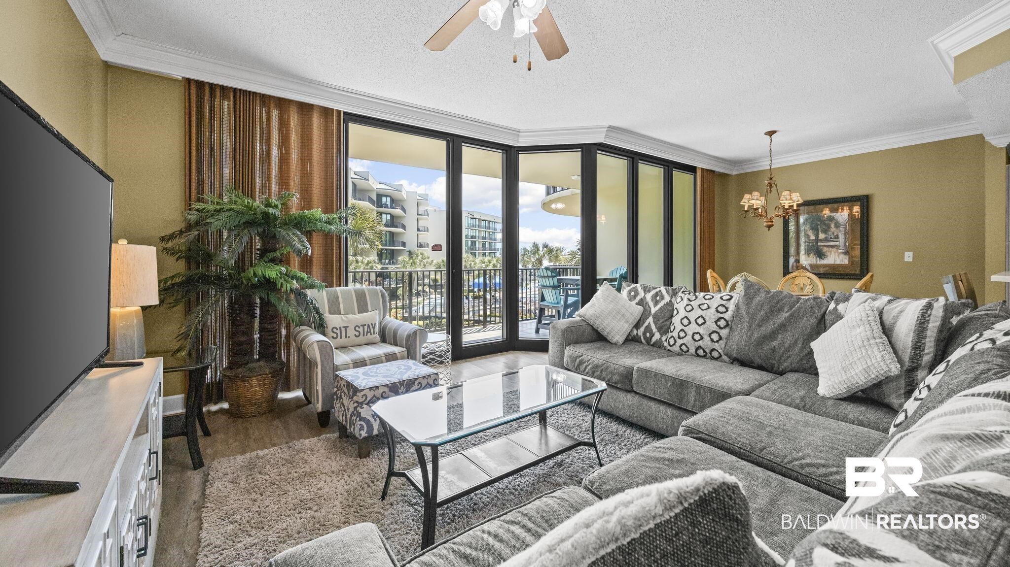 27580 Canal Road, Unit 214 BS 62 Orange Beach, AL 36561 - Photo 2 of 23 Living room featuring expansive windows, ceiling fan, ornamental molding, hanging lights, and dark wood-style flooring