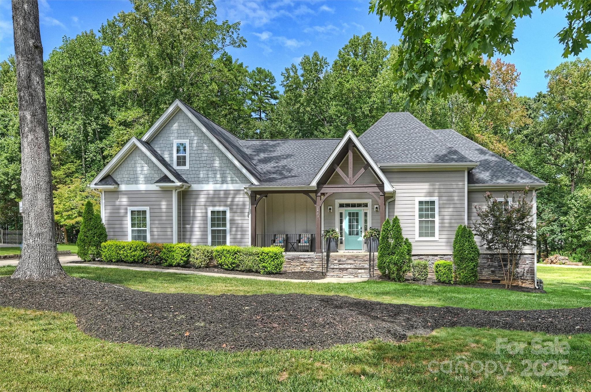 a front view of a house with a garden