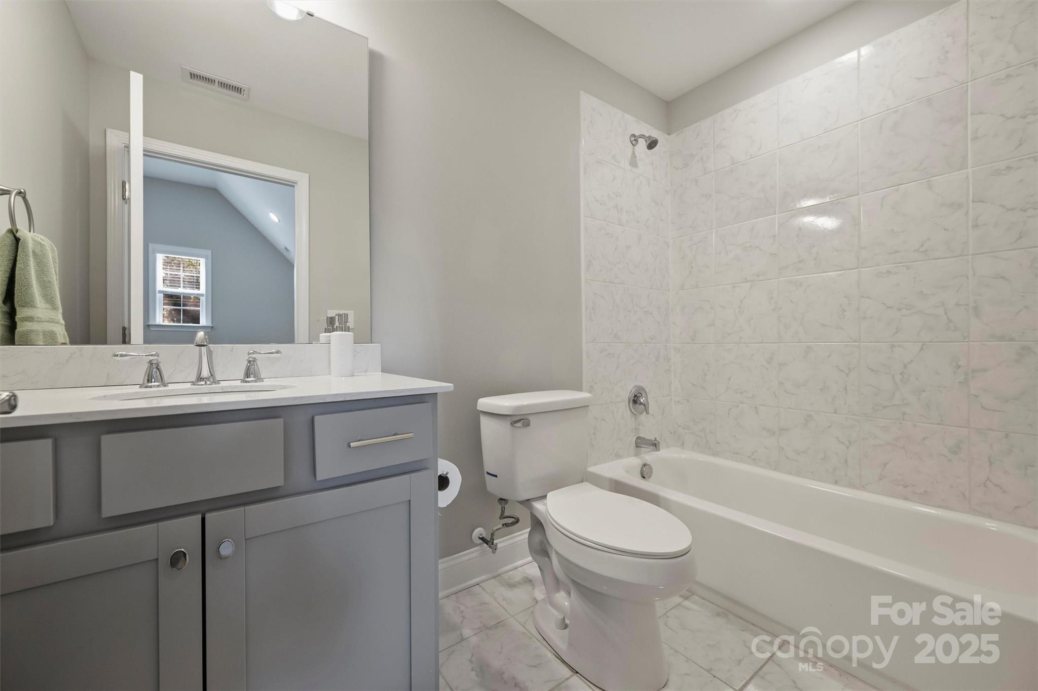 2413 Rocky River Road Charlotte, NC 28213 - Photo 23 of 46 a bathroom with a toilet a sink a mirror and a bathtub