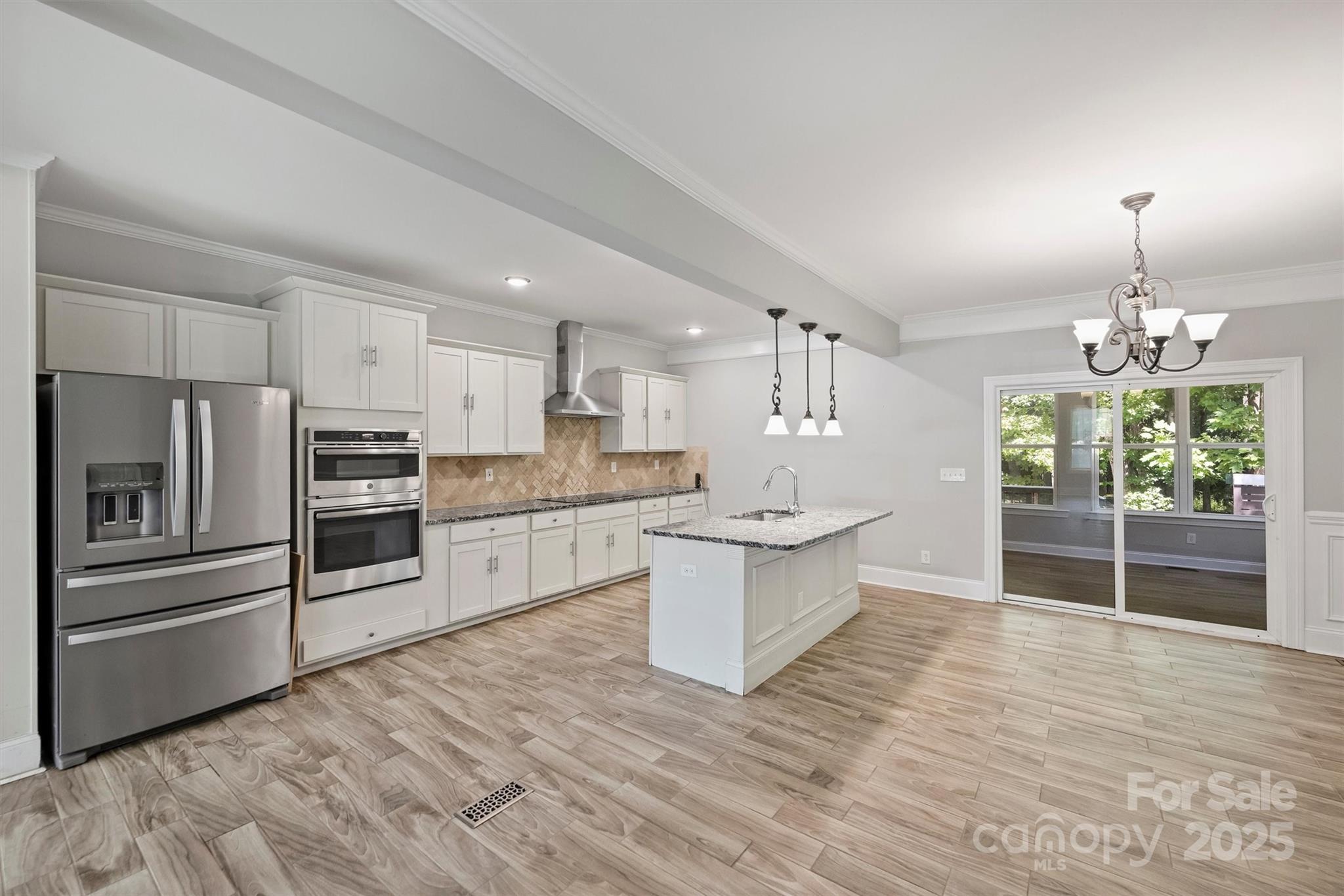 2413 Rocky River Road Charlotte, NC 28213 - Photo 31 of 46 a large kitchen with kitchen island a sink stainless steel appliances and cabinets