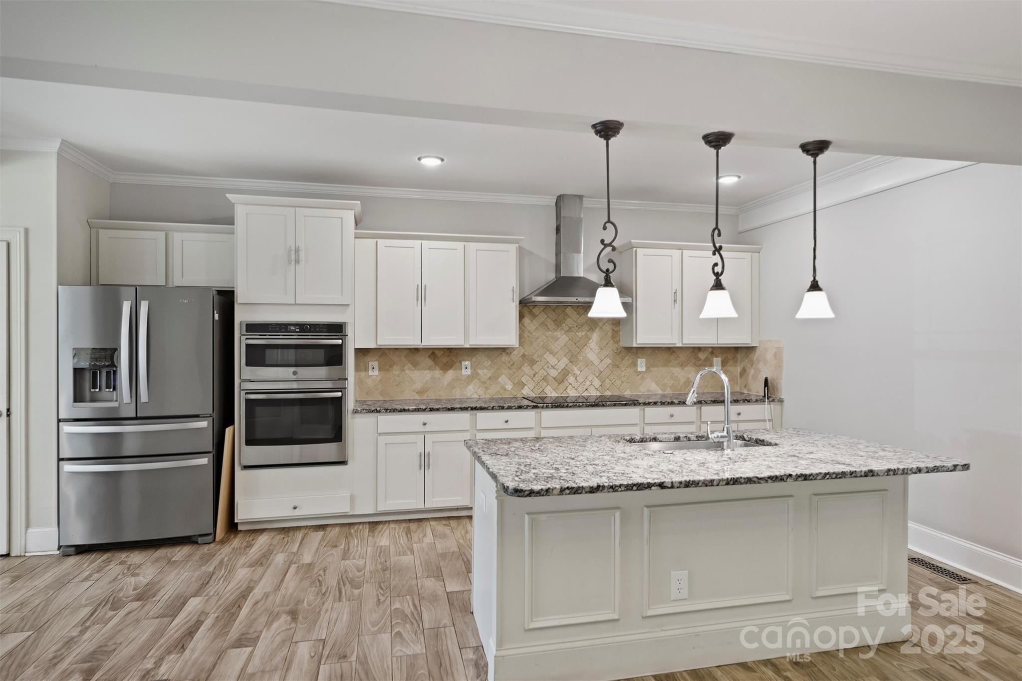 2413 Rocky River Road Charlotte, NC 28213 - Photo 33 of 46 a kitchen with kitchen island granite countertop a sink a counter space appliances and cabinets