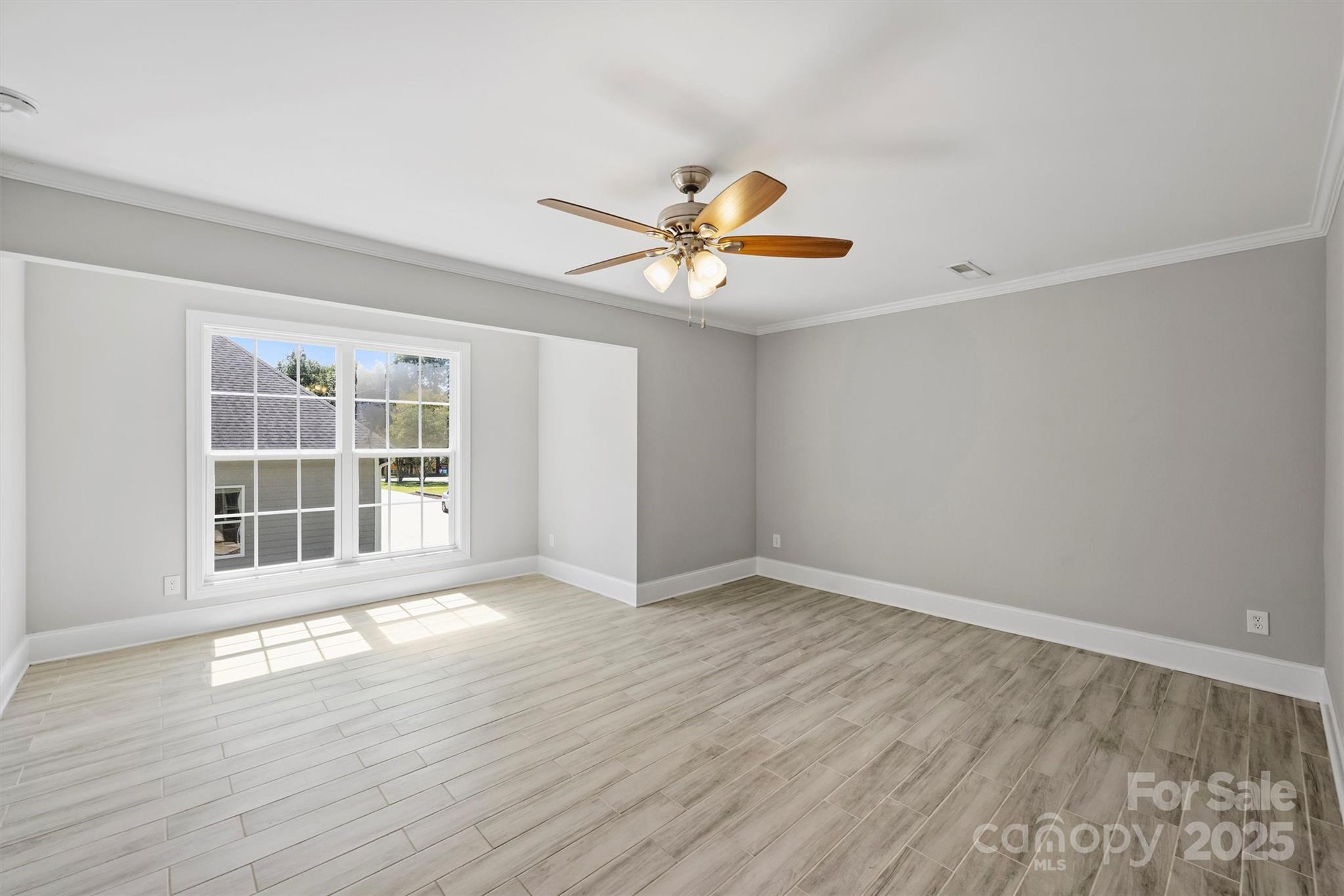 2413 Rocky River Road Charlotte, NC 28213 - Photo 37 of 46 a view of an empty room with a window and wooden floor