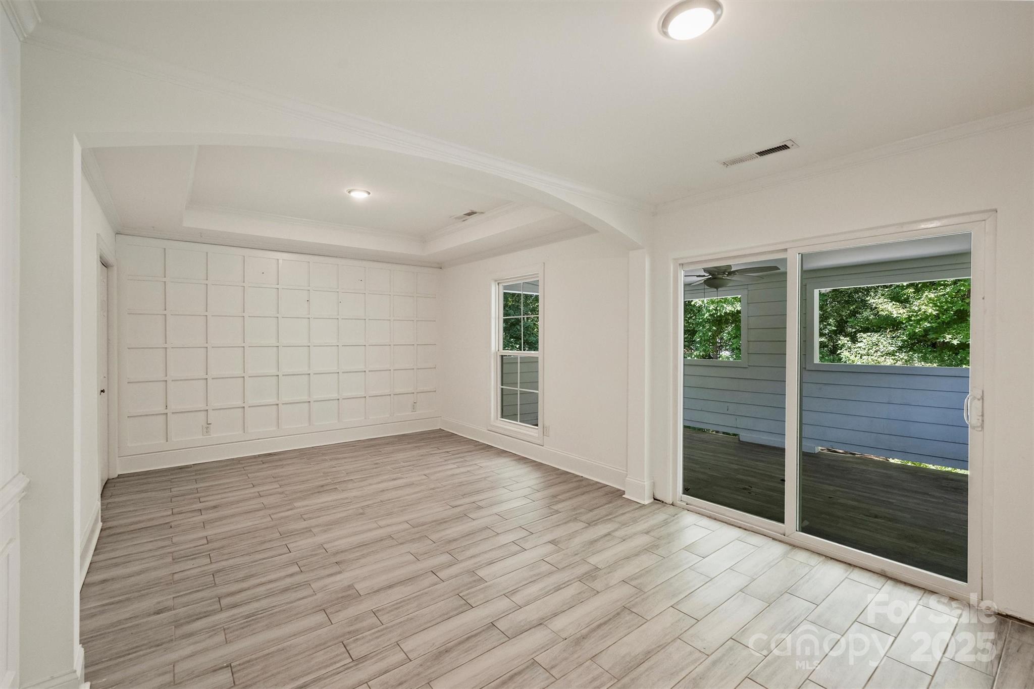 2413 Rocky River Road Charlotte, NC 28213 - Photo 38 of 46 an empty room with wooden floor and windows