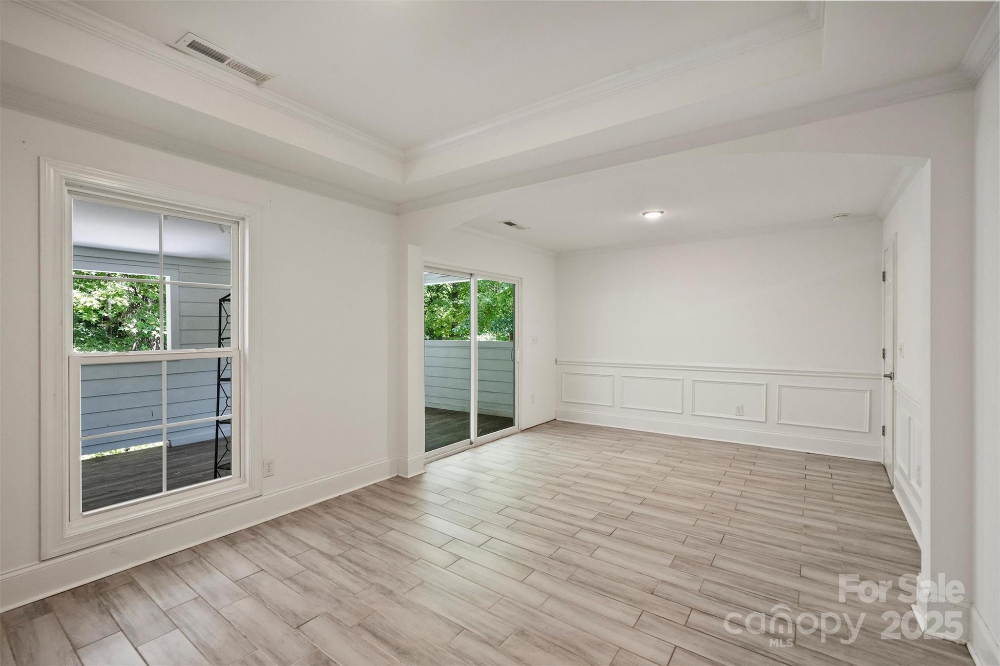 2413 Rocky River Road Charlotte, NC 28213 - Photo 39 of 46 an empty room with wooden floor and windows