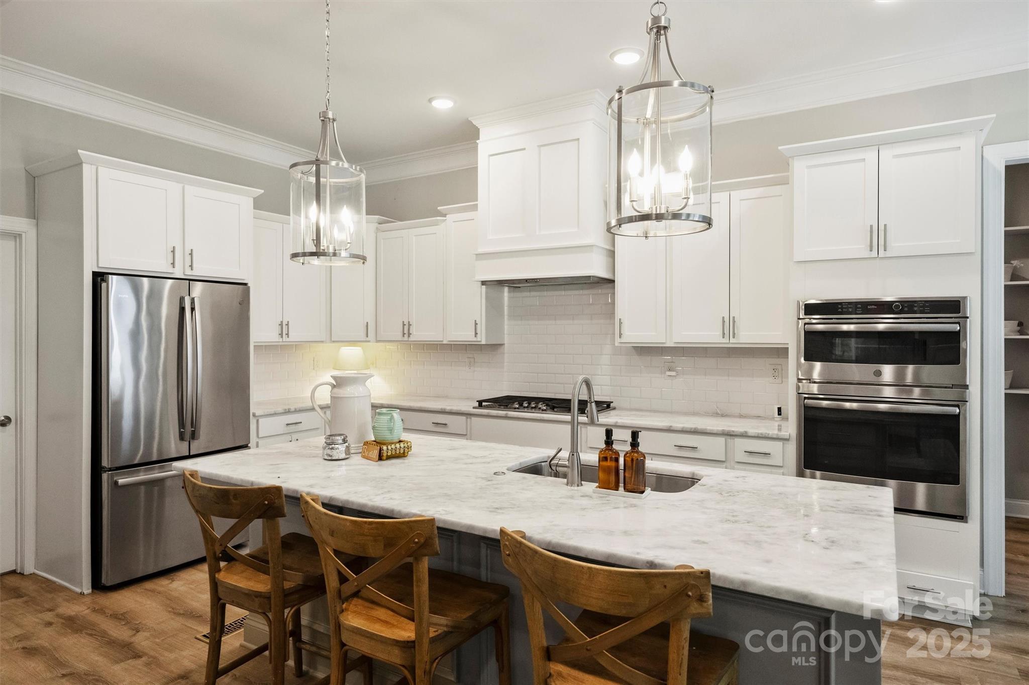 2413 Rocky River Road Charlotte, NC 28213 - Photo 6 of 46 a kitchen with stainless steel appliances granite countertop a dining table chairs stove refrigerator and cabinets