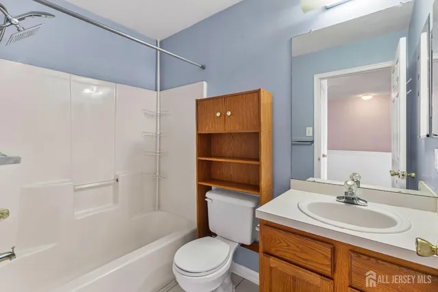 a bathroom with a sink toilet vanity and shower