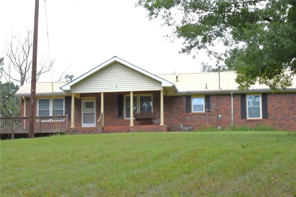 a front view of a house with a garden and yard