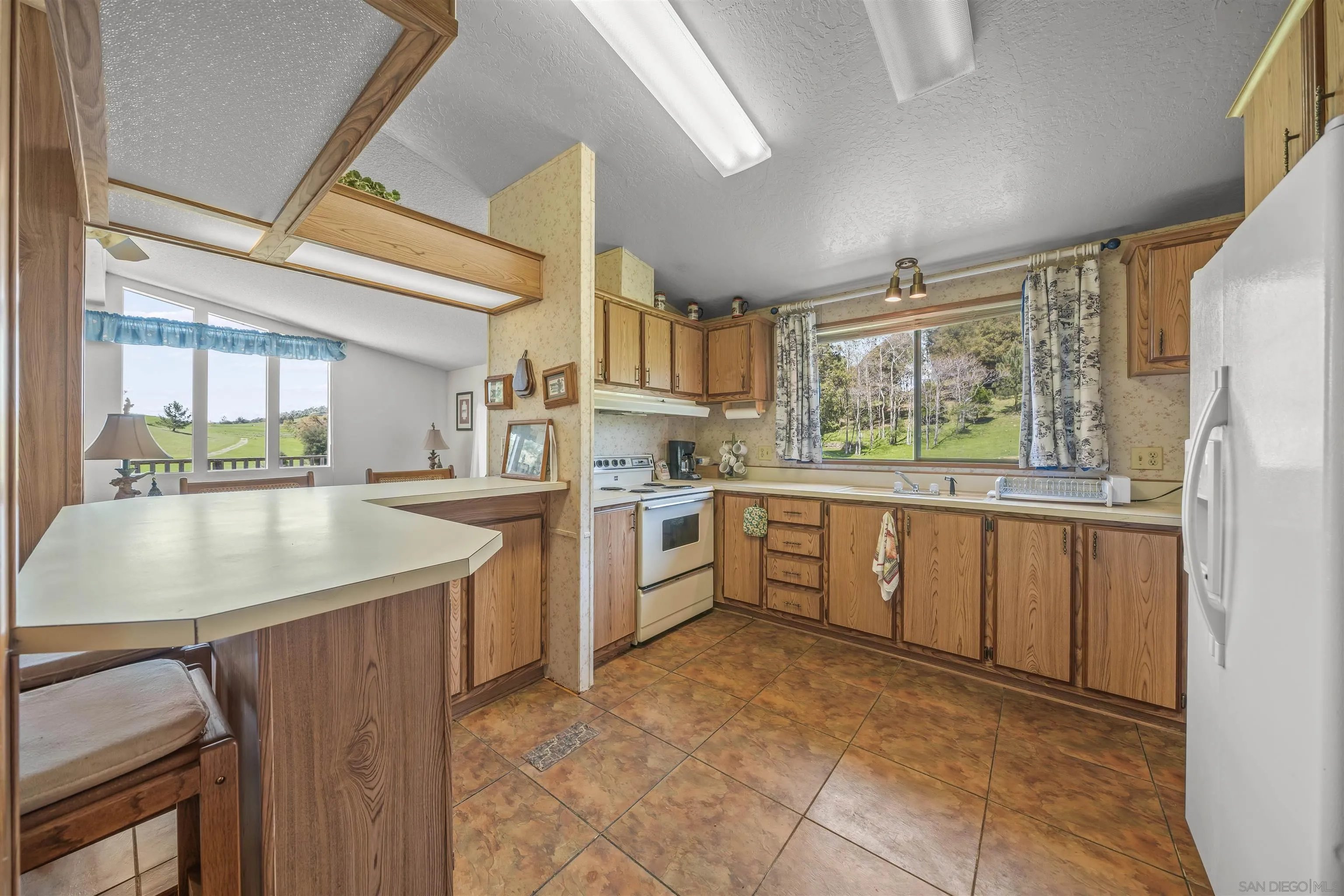 2464 Wynola Road Julian, CA 92036 - Photo 27 of 50 a kitchen with a sink stove and cabinets