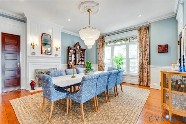a living room with furniture kitchen view and a potted plant