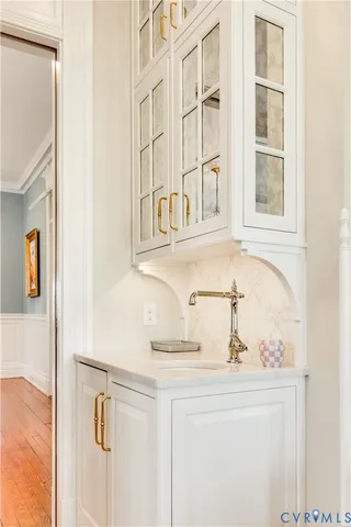 a kitchen with a stove a sink and a window