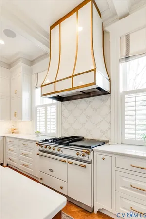 a large kitchen with sink a refrigerator and chairs