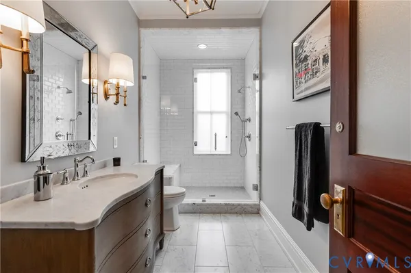 a bedroom with a bed chair and fireplace