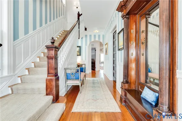 a view of an entryway with wooden floor and a livingroom