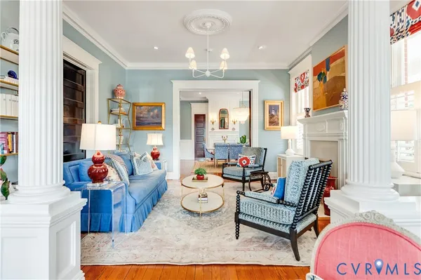 a living room with fireplace furniture and a large window