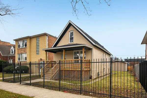 a view of a house with wooden fence