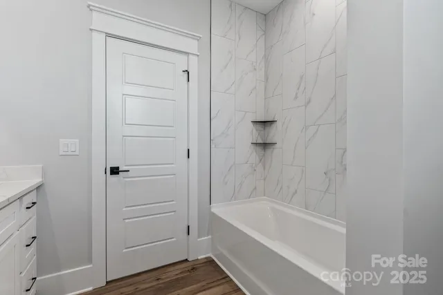 a bathroom with a bathtub and shower