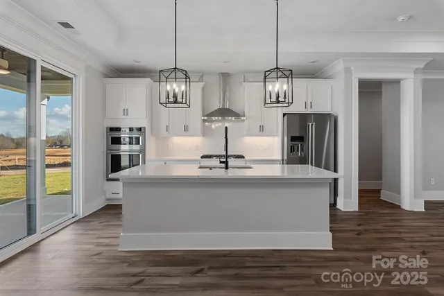 a view of kitchen with granite countertop cabinets and stainless steel appliances