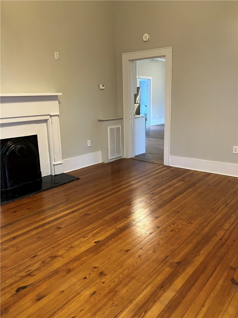 3 Wardlaw Street Pelzer, SC 29669 - Photo 2 of 6 Rich hardwood floors complement a fireplace (non working), creating a comforting living space.