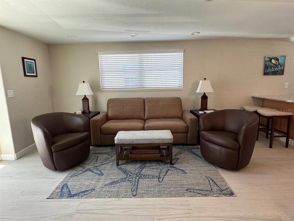 6154 Midnight Pass Road, Unit C15 Sarasota, FL 34242 - Photo 2 of 9 a living room with furniture and a window