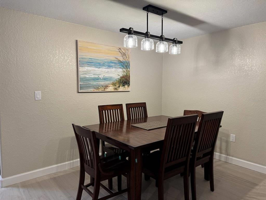 6154 Midnight Pass Road, Unit C15 Sarasota, FL 34242 - Photo 5 of 9 a view of a dining room with furniture