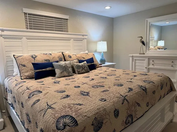 a bedroom with a bed and a mirror